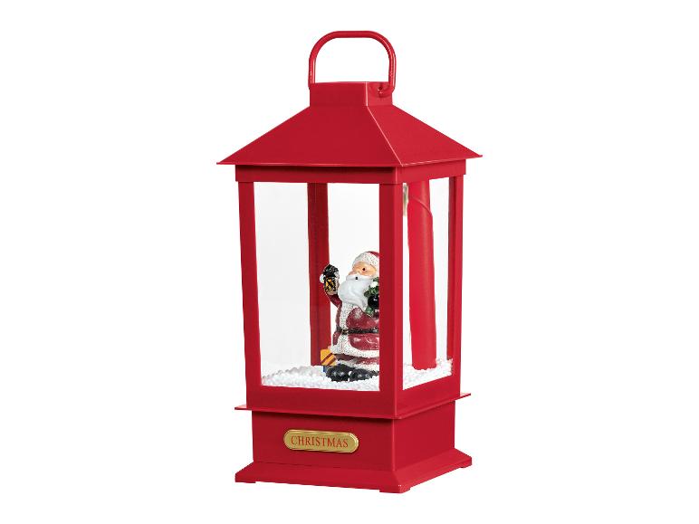 Rode kerstlantaarn met kerstman en sneeuw