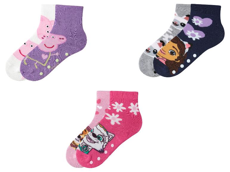 Drie paar kindersokken met Peppa Pig, Dora en Paw Patrol figuren.