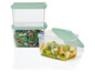 Drie transparante opbergbakken met groene deksels, gevuld met salade en fruit.