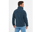 Man van achteren gezien, draagt een donkerblauwe fleece trui met hoge kraag en jeans.