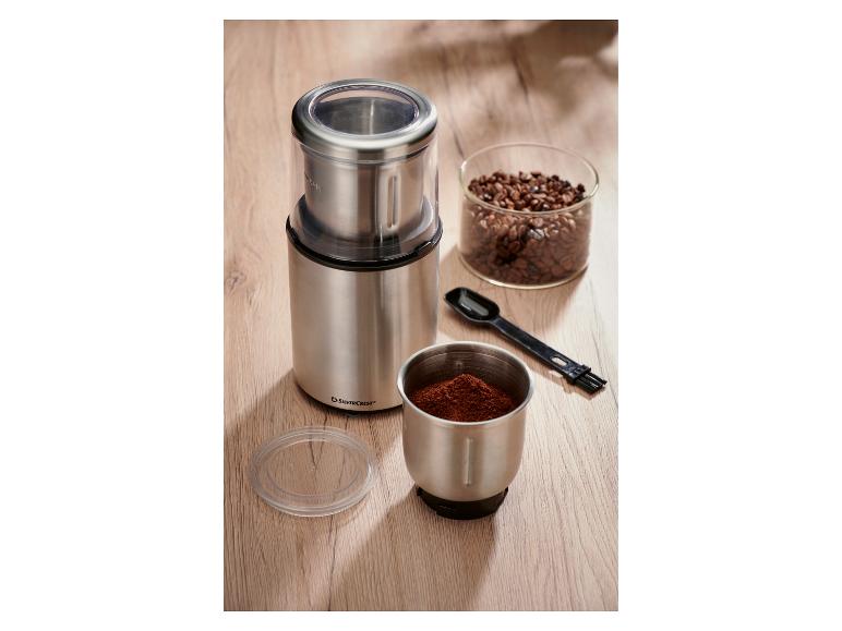 SilverCrest roestvrijstalen koffiemolen met koffiebonen en gemalen koffie.