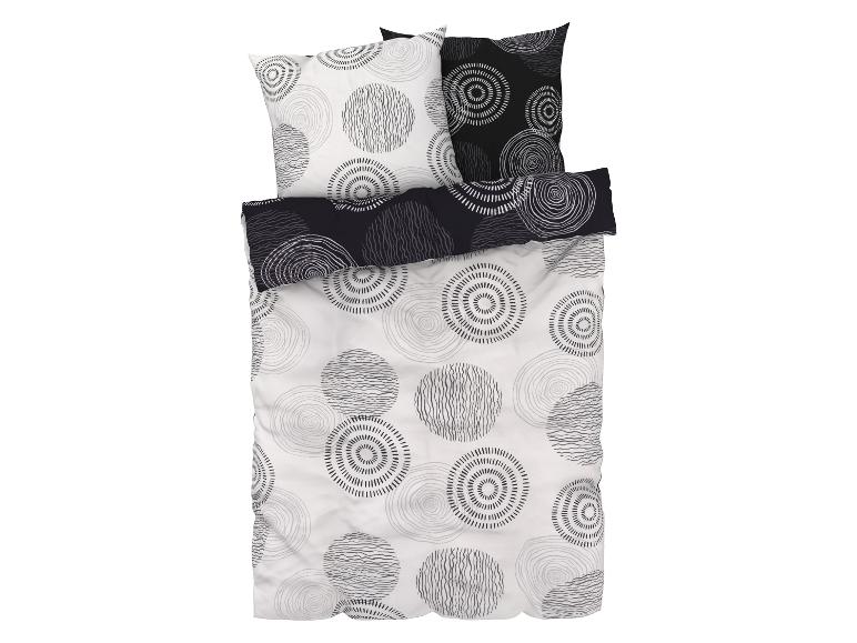 Een dekbedovertrek en kussenslopen met een abstract cirkelpatroon.