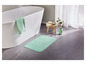 Een groene badmat voor in de badkamer.