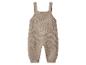 Beige gebreide baby romper met brede bandjes.