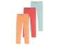 Drie paar leggings in oranje, roze en mintgroen.