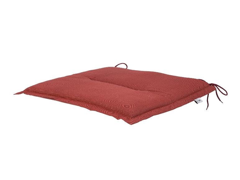 Rood stoelkussen met strikken, geweven patroon en LIVARNO HOME label.