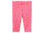 Roze baby legging met witte stippen.
