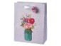 Paarse stippen cadeauzak met een boeket bloemen in een pot, met een bloemenlabel.