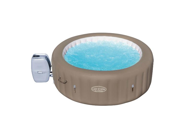 Opblaasbare jacuzzi met turquoise water en externe pomp.
