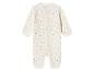 Witte baby romper met gekleurde stippen.