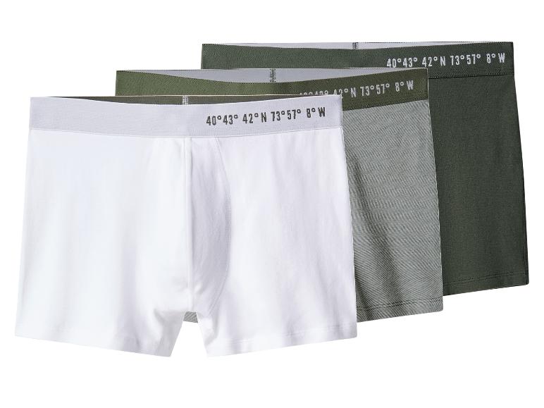 Drie witte, grijze en groene boxershorts met coördinaten op de tailleband