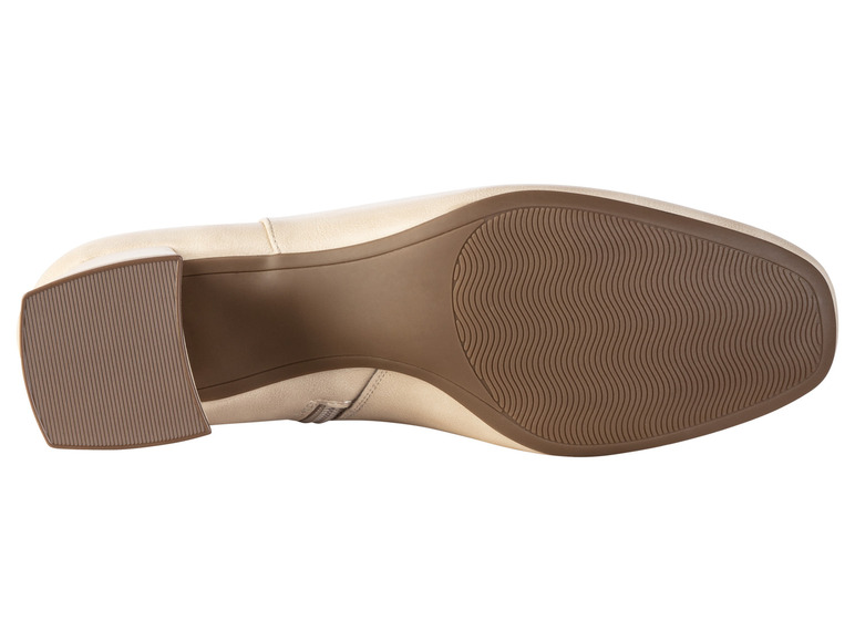 De onderkant van een beige enkellaars met een brede hak.