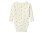 Crèmekleurige baby romper met lange mouwen en een patroon van kleine gele eendjes.