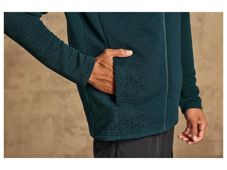 Een donkergroene fleece trui met ritssluiting