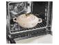 Crèmekleurige braadpan in een oven op een rooster.