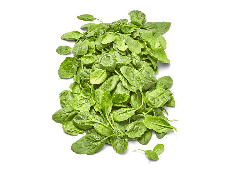 Verse groene babyspinazieblaadjes op een zwarte achtergrond.