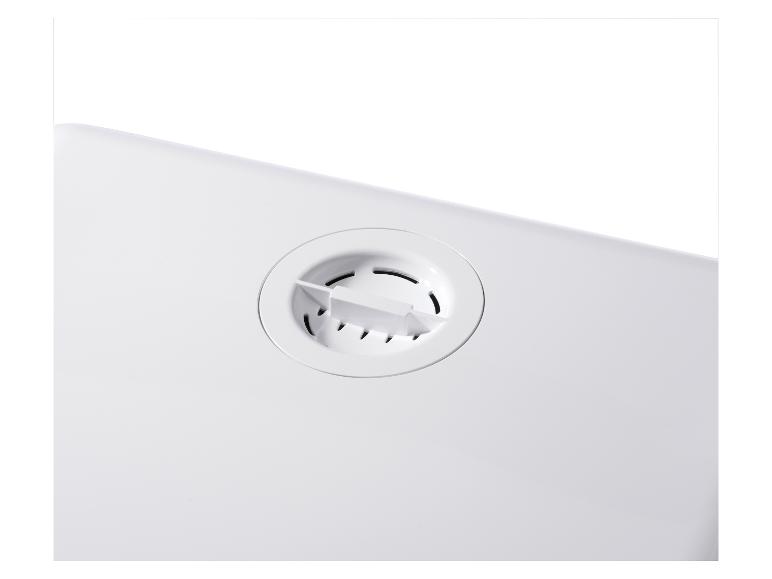 Wit plastic onderdeel met een ronde ventilatieopening.