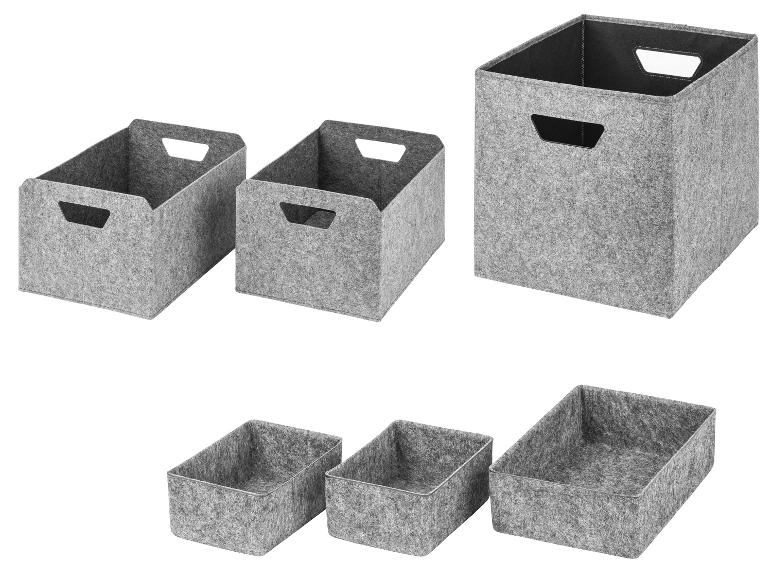 Grijze vilten opbergdozen en manden in diverse maten voor thuisorganisatie.