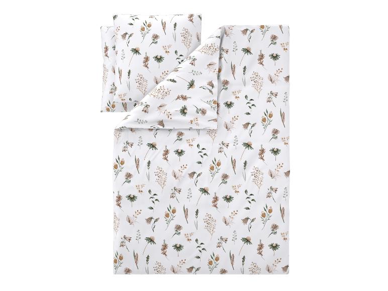 Wit katoenen beddengoedset met een patroon van bruin-groene bloemen en bladeren.