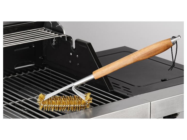 BBQ-reinigingsborstel op een roestvrijstalen barbecuegrill