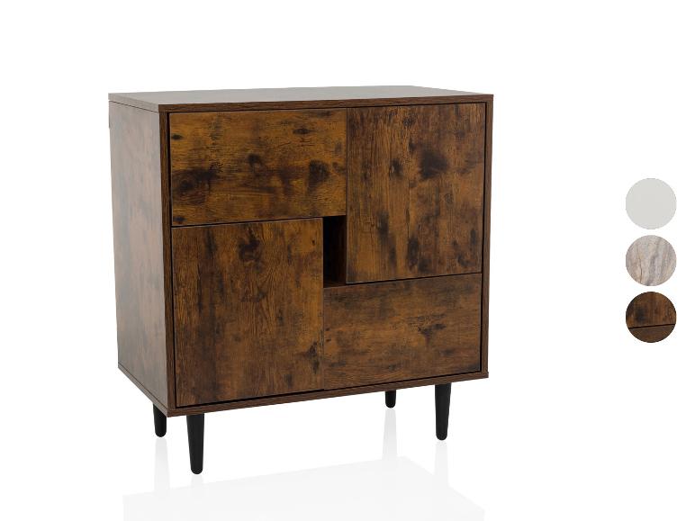 Bruine houtlook ladekast met zwarte poten en drie kleurstaaltjes.