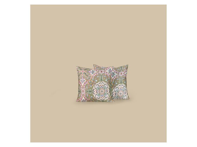 Twee decoratieve kussens met groen en roze bloemenpatroon op een beige achtergrond.