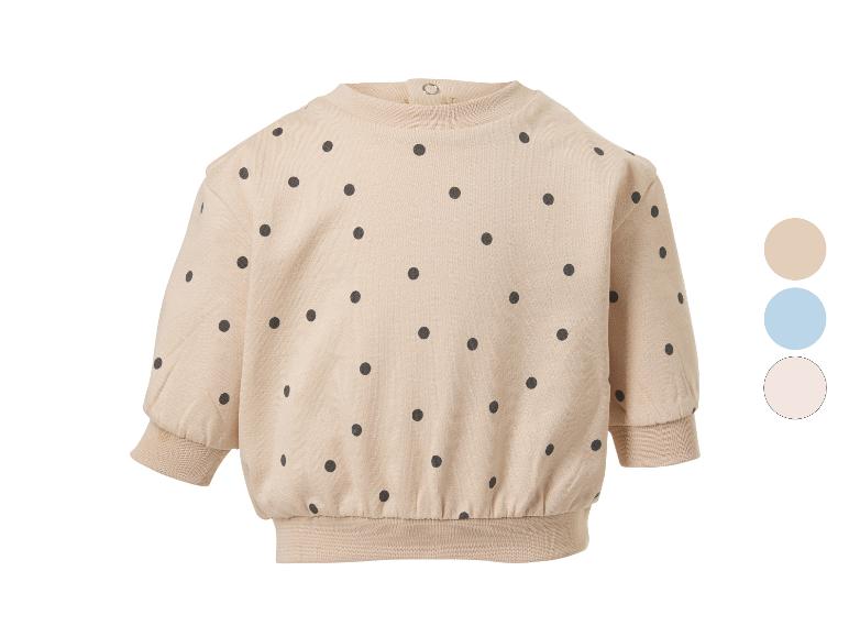 Beige baby sweatshirt met zwarte stippen en drie kleuropties.
