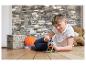 Jongen speelt met magnetisch constructiespeelgoed op een houten vloer.