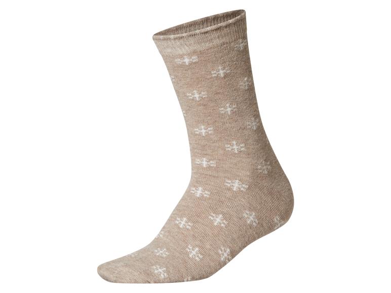 Beige sok met witte sneeuwvlokpatronen.