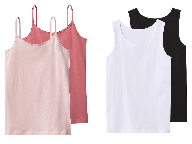 Twee roze spaghettibandjeshemdjes en twee witte en zwarte tanktops.