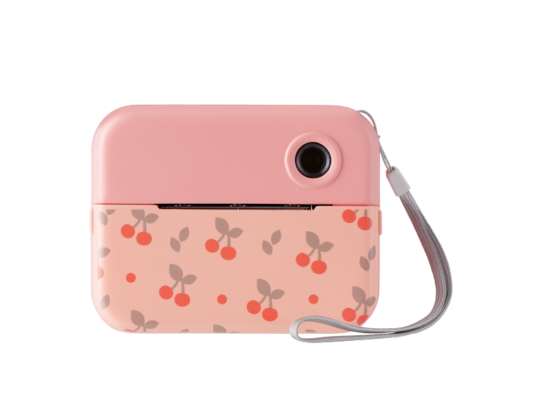 Roze instant camera met kersenpatroon en polsbandje.