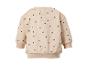 Beige kindertrui met zwarte stippen, achteraanzicht.