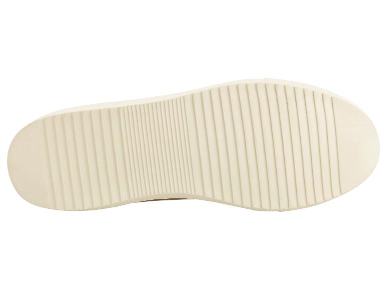 Onderkant van een beige schoenzool met verticale ribbels