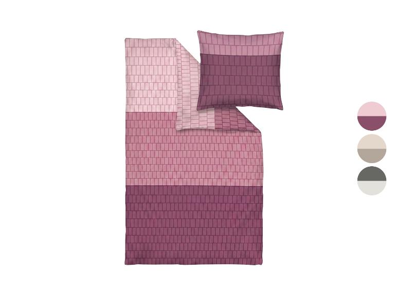 Beddengoed in roze en paarse tinten met geometrisch patroon, met kleurenpalet.