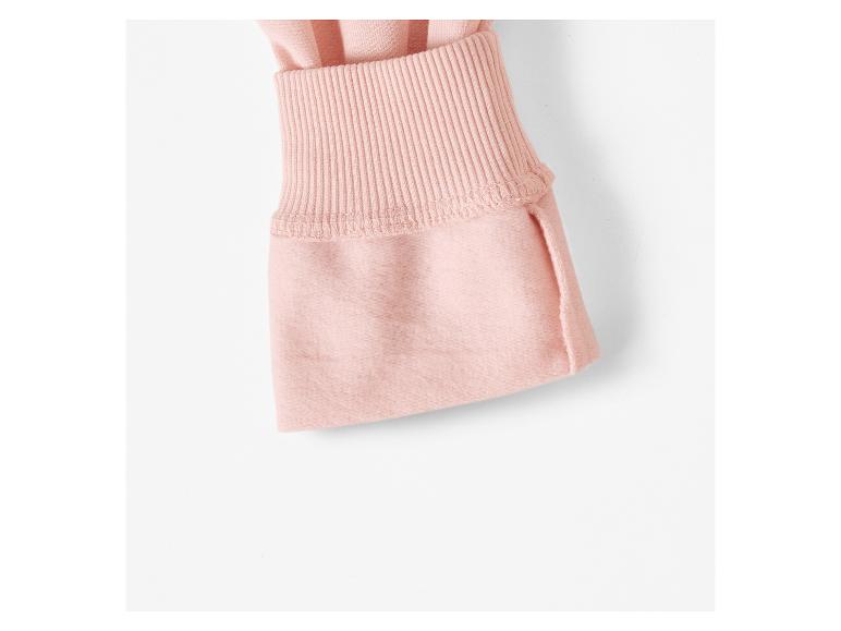 Detail van een roze gebreide trui