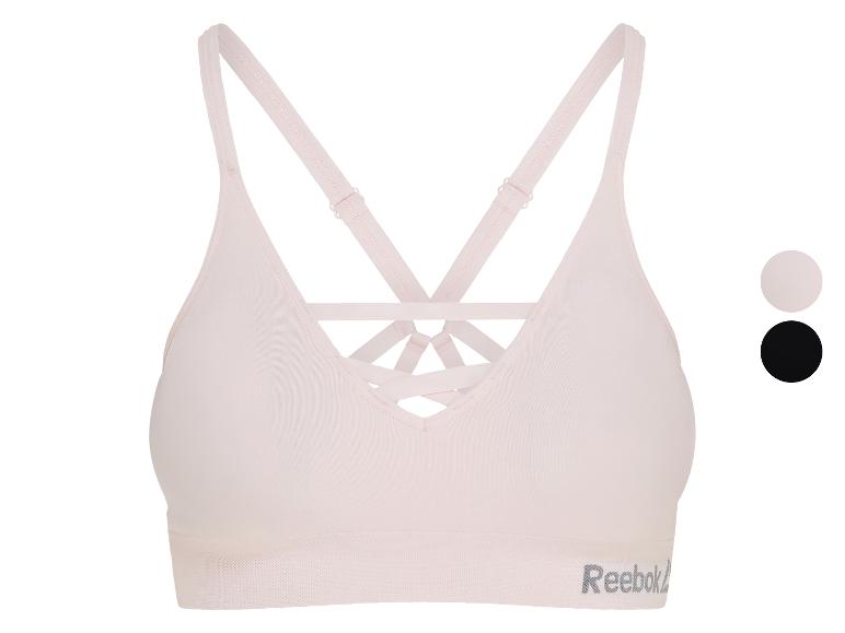 Lichtroze sportbeha met gekruiste rugbandjes en een subtiele getextureerde band