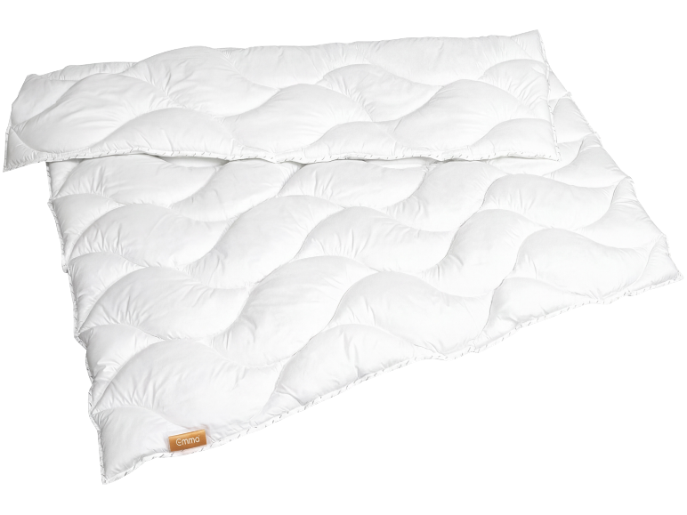 Wit dekbed met een golvend gewatteerd patroon en een klein bruin label.