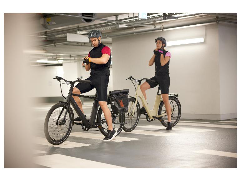 Twee fietsers met elektrische fietsen in een parkeergarage.