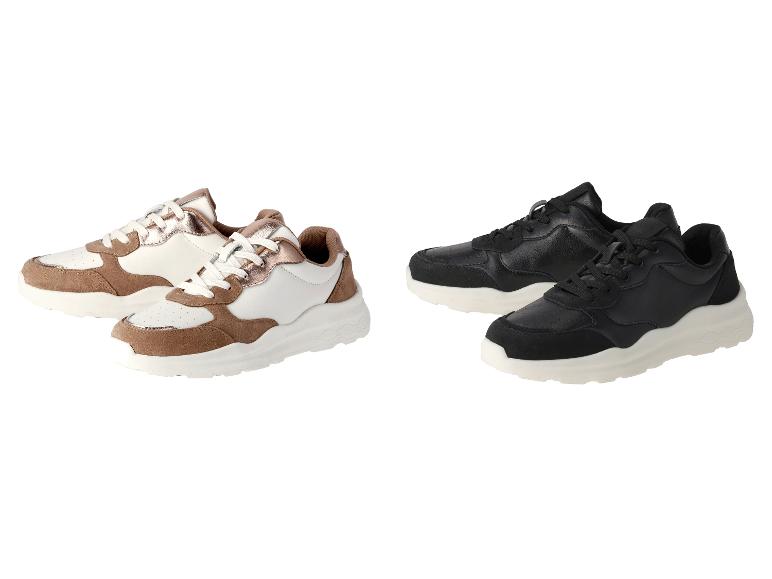 Witte en zwarte sneakers met beige details.