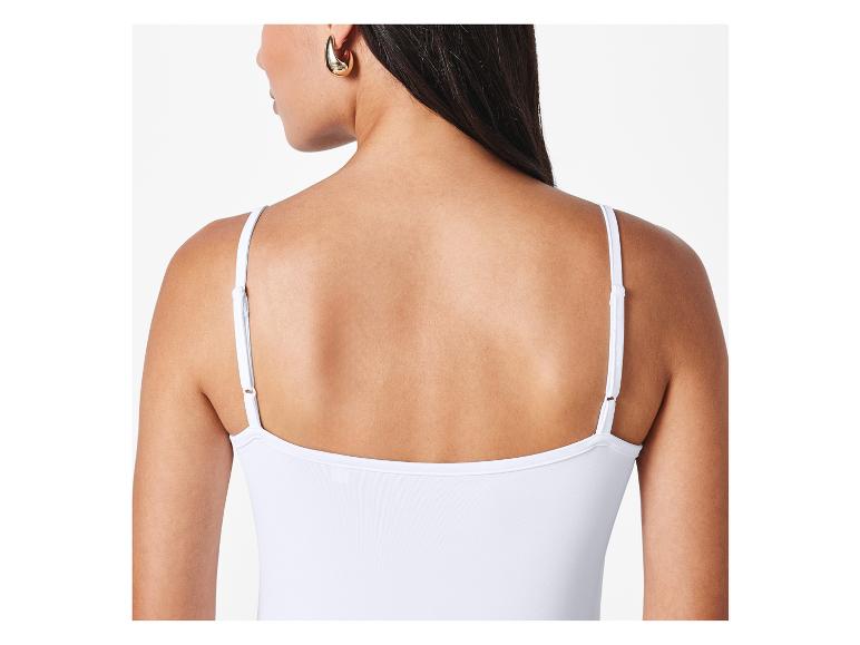 Witte spaghettitop en gouden oorbellen.