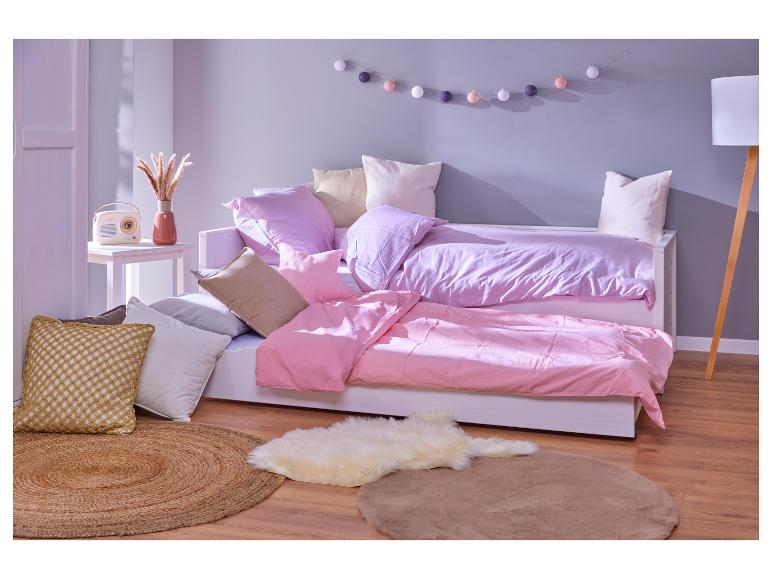 Meisjesbed met roze en paarse beddengoed.