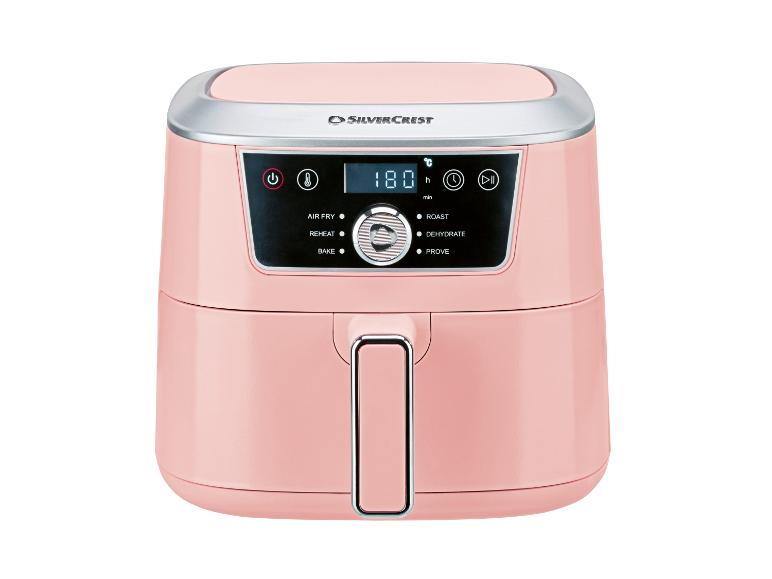 Roze airfryer met digitaal display dat 180 graden Celsius en diverse kookmodi toont.