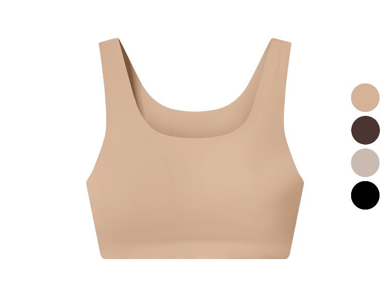 Huidkleurige sporttop met kleurenpalet: beige, bruin, grijs en zwart.