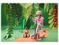Meisje met helm op scooter met knuffel in papieren jungle.