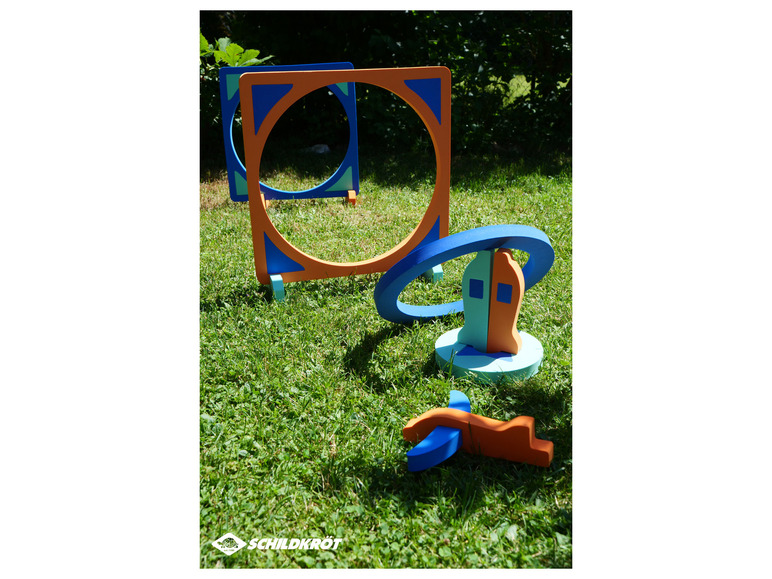 Schildkröt speelgoed, met ringen, vormen en een vliegtuig in de tuin.