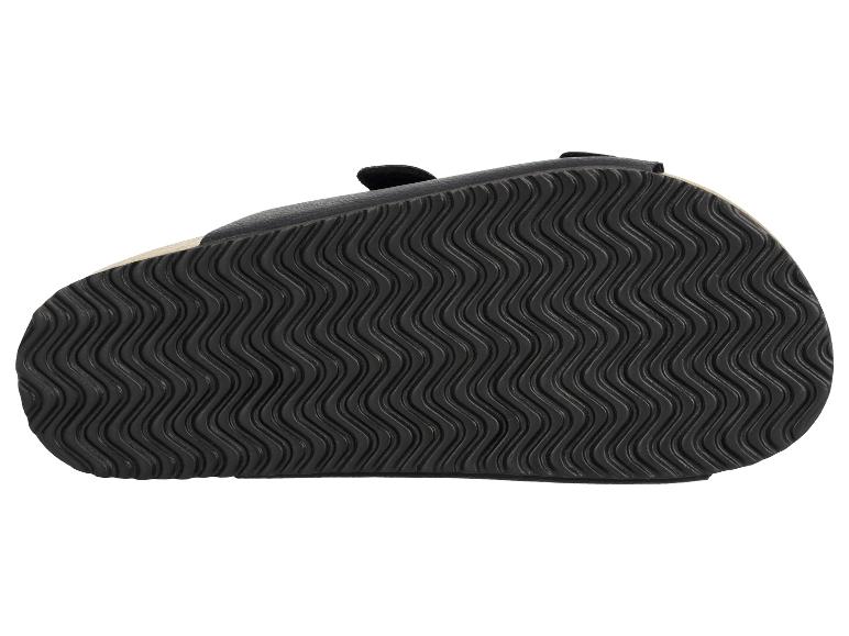 Zwarte sandaalzool met golvend patroon.