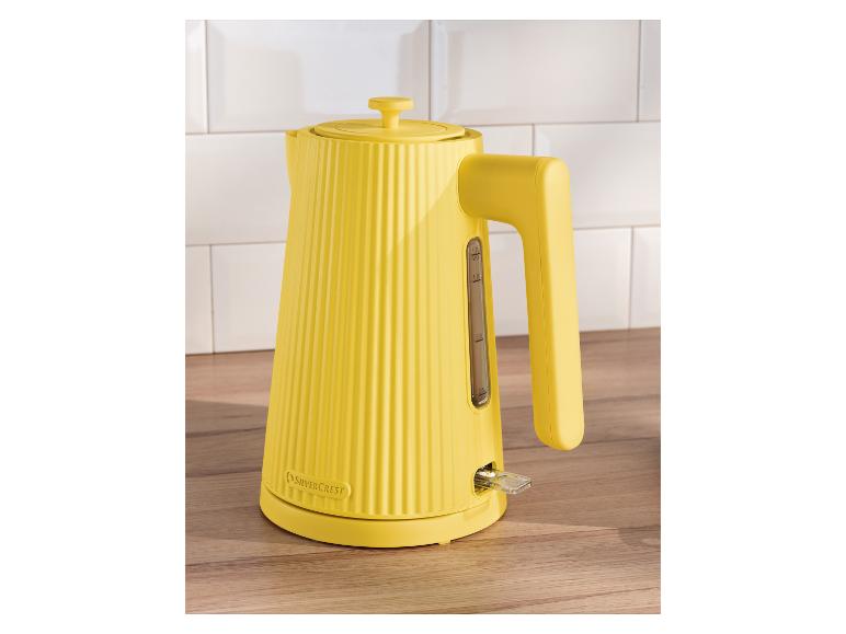 Gele geribbelde waterkoker van SilverCrest op een houten aanrecht met witte tegels.