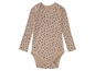 Beige baby romper met blauwe stippen.