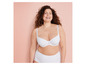 Een vrouw draagt een witte bh en een witte slip.