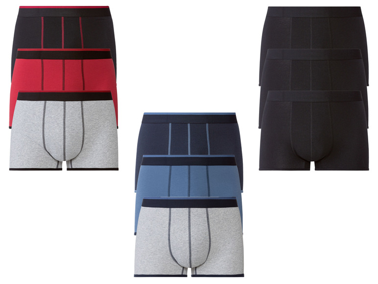 Drie paar boxershorts in verschillende kleuren: grijs, donkerblauw en zwart.